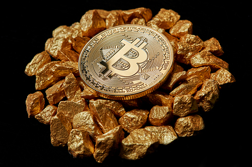 Studio shot of golden Bitcoin coin on mound of gold on black background . Bitcoin digital virtual cryptocurrency. Concept image