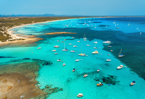 Boats and luxury yachts in transparent sea at sunny day in summer in Mallorca, Spain. Aerial view. Colorful seascape with bay, azure water, sandy beach, blue sky. Balearic islands. Top view. Travel
