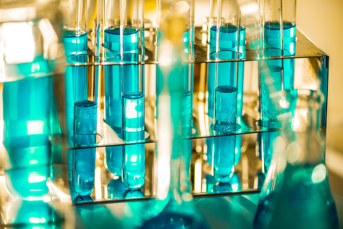 Glassware and blue liquid equipment in chemical laboratories