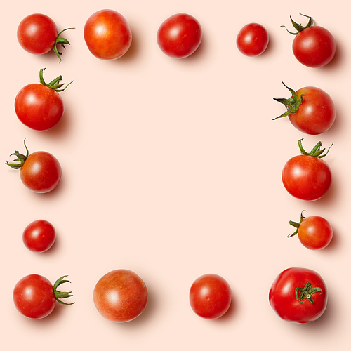 The rectangular frame of cherry tomatoes isolated on a pink background. Unusual place for text about cooking, nutrition, healthy lifestyles, Italian food, organic food, etc.