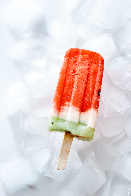Frozen natural vanilla watermelon smoothies on a stick on ice cubes. Ice lolly. Top view