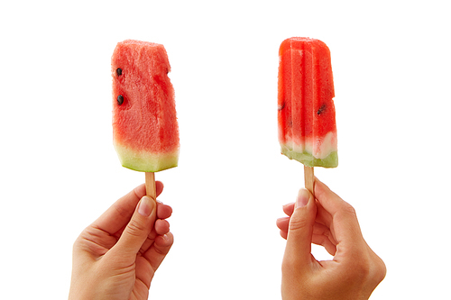 Juicy fresh slices of a watermelon on a stick hold female hands on a white background with a copy space. The concept of healthy berry ice cream lolly or dessert.