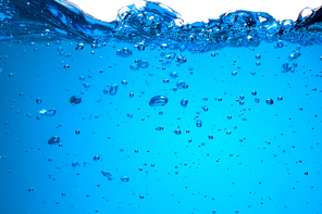 Splash of blue water with bubbles. Underwater image