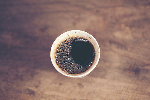 Cup of Dripping fresh hot coffee on the wood table