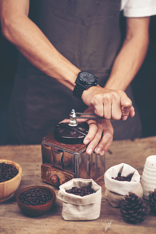 Vintage coffee grinder and beans on wooden background