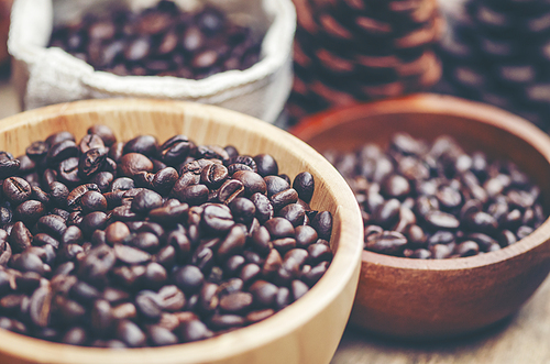 coffee beans on wooden background, arabica coffee, vintage filter image