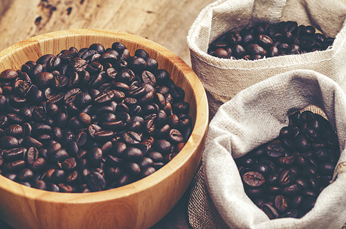 coffee beans on wooden background, arabica coffee, vintage filter image