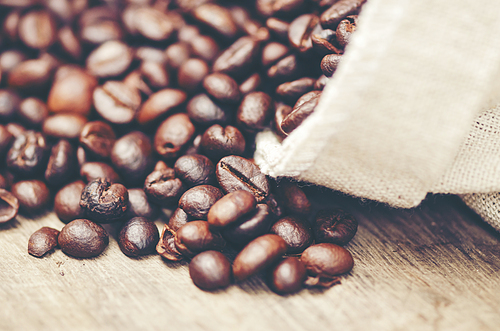 coffee beans on wooden background, arabica coffee, vintage filter image