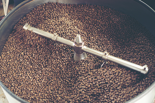 fresh coffee beans in roast machine, arabica roasted coffee ,vintage filter image