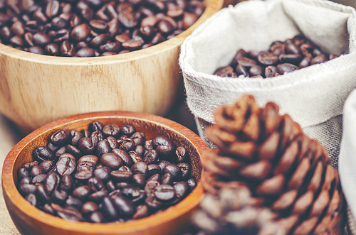 coffee beans on wooden background, arabica coffee, vintage filter image