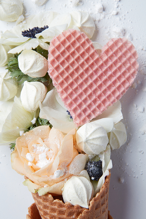 Waffle cone with organ flower and heart on a white background