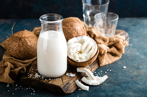Fresh coconut milk in glass bottle, vegan non dairy healthy drink