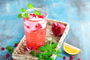 Infused pomegranate water with fresh lemon and ice, cold healthy refreshing and detox drink
