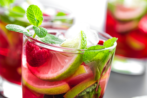 Raspberry mojito cocktail with lime, mint and ice, cold, iced refreshing drink or beverage