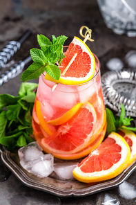 Grapefruit and fresh mint cocktail with juice, cold summer citrus refreshing drink or beverage with ice