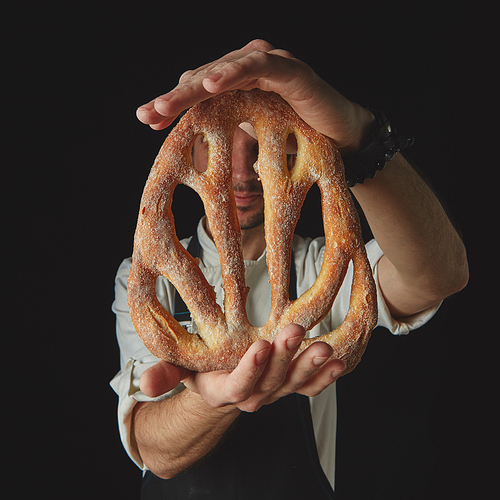 Homemade fougas bread in the hands of a baker