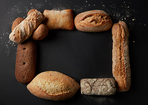 Baking and cooking concept background. Top view of different kinds of bread represented in form of frame. Copy space in middle may be used for your ideas, emotions.