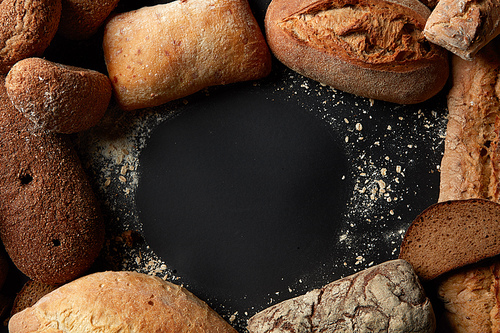 Fresh bread in round frame with copy space over black