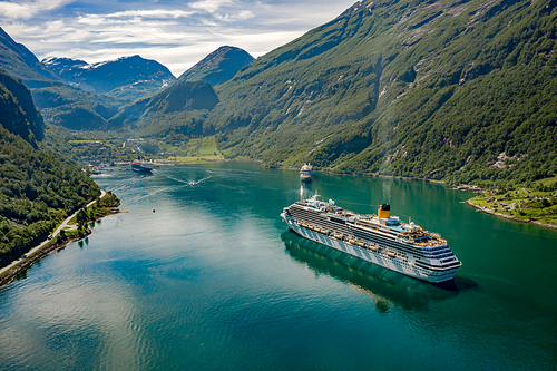 Cruise Ship, Cruise Liners On Geiranger fjord, Norway. The fjord is one of Norway's most visited tourist sites. Geiranger Fjord, a UNESCO World Heritage Site