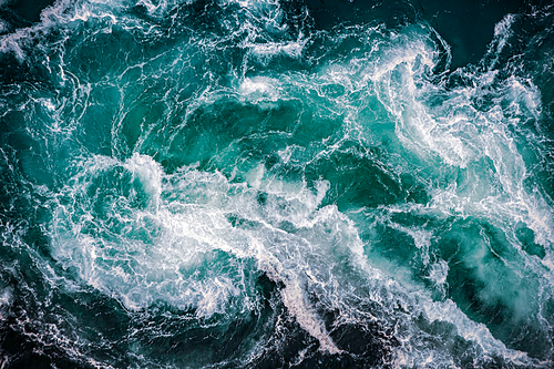 Abstract background. Waves of water of the river and the sea meet each other during high tide and low tide. Whirlpools of the maelstrom of Saltstraumen, Nordland, Norway