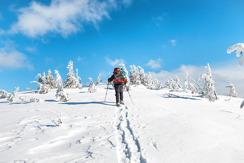 Man hiking on snow in winter mountains
