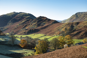 Epic Autumn Fall landscape image of Sleet Fell and Howstead Brow in Lake District with beautiful early morning light in valleys and on hills