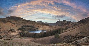 Epic drone landscape image of Blea Tarn in Lake District during Autumn Fall sunrise