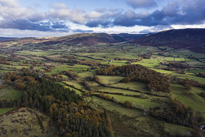 Stunning aerial drone vibrant Autumn Fall landscape image of view from Low Fell in Lake District