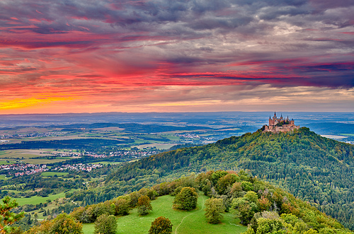 Hilltop Hohenzollern Castle on mountain top at sunset in Swabian Alps, Baden-Wurttemberg, Germany