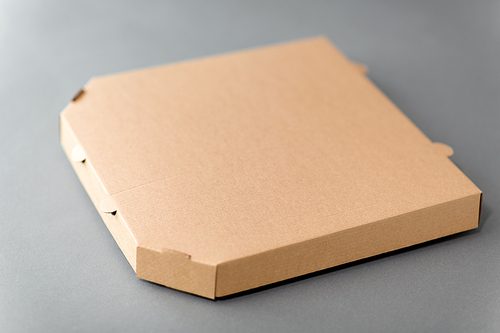 recycling, reuse and ecology concept - disposable brown takeaway food or pizza in brown paper box on grey background