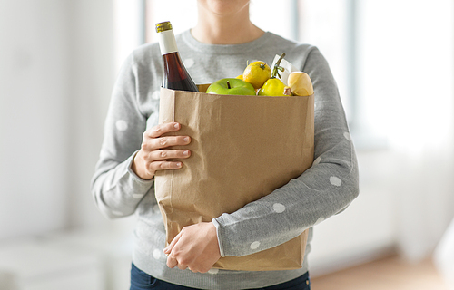 shopping, healthy eating and eco friendly concept - close up of woman with paper bag full of food