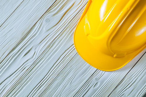 construction helmet on vintage white wooden painted boards close up