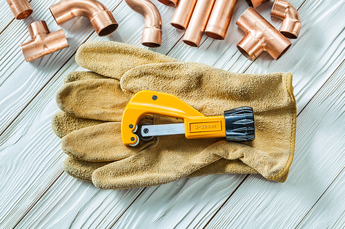 pipe cutter on construction glove and fittings