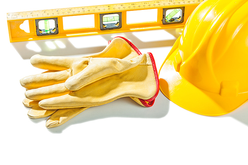 construction tools gloves level yellow helmet isolated on white