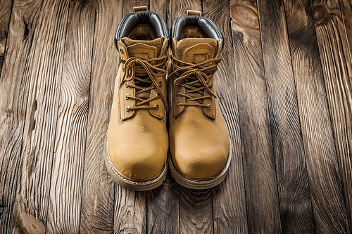 construction tools sawety wear leather working boots on vintage wooden boards