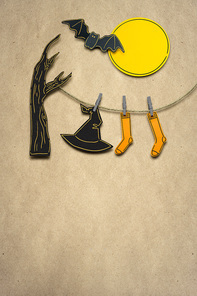 Creative halloween concept photo of witches hat and stockings made of paper on brown background.