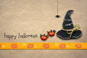 Creative halloween concept photo of witches hat made of paper on brown background.