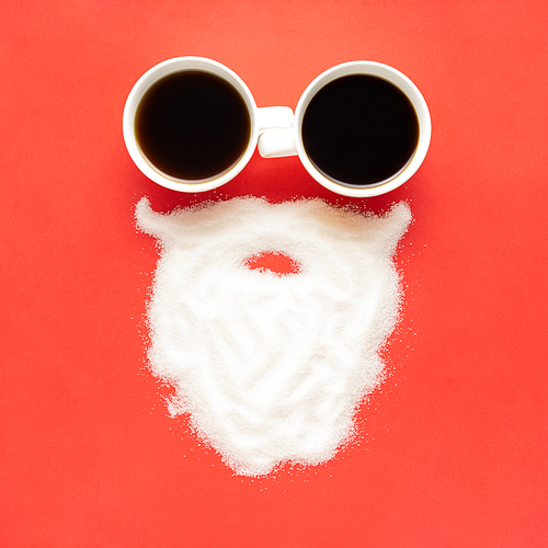 Creative concept still life christmas new year holiday photo of espresso coffee cups mugs drink beverage with santa clause face beard made of sugar on red background.