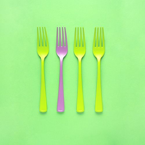Creative concept still life food diet health photo of painted forks tableware utensil cutlery on green background.