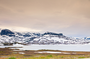 Norway hiking area, scenic mountains landscape, hills and frozen lake