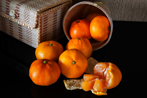 many tangerine on background wicker boxes with reflection