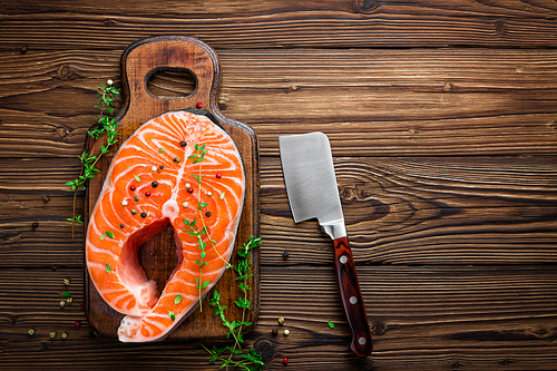 raw salmon fish steak on wooden rustic background