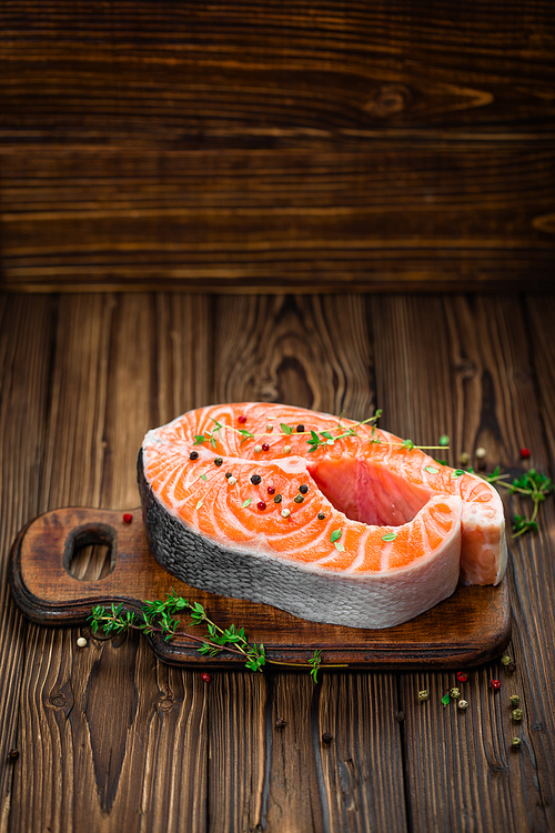 raw salmon fish steak on wooden rustic background