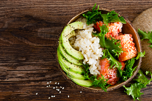 hawaiian poke coconut bowl with grilled salmon fish, food and avocado. healthy food. top view