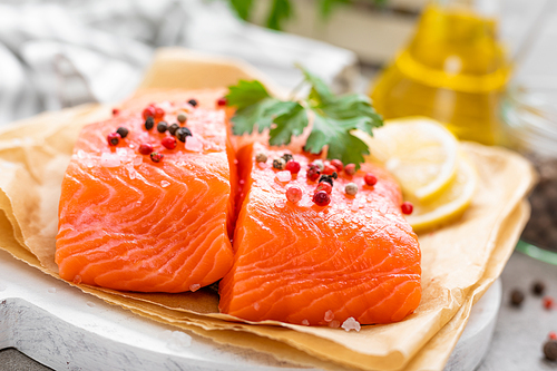Fresh raw salmon fish fillet on white kitchen background