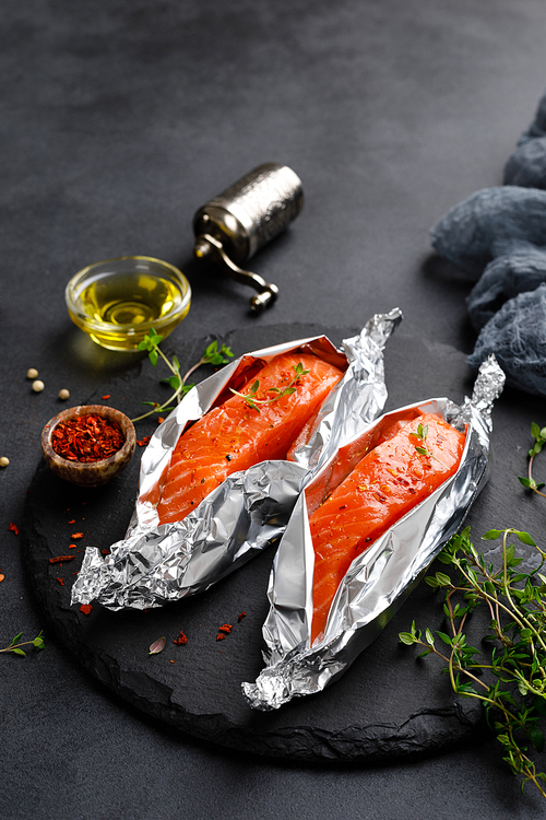 raw salmon fish fillet in foil on  background