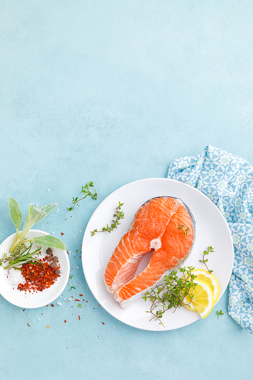 Fresh raw salmon fish steak with ingredients for cooking