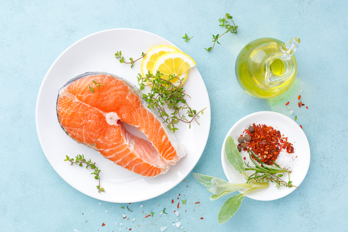 Fresh raw salmon fish steak with ingredients for cooking