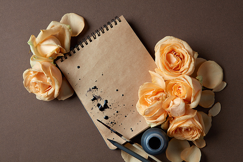 Diary or notebook with yellow roses around for ideas and expressing emotions. Blank copy space for writing congratulations. Women's Day concept. Valentine's Day concept.