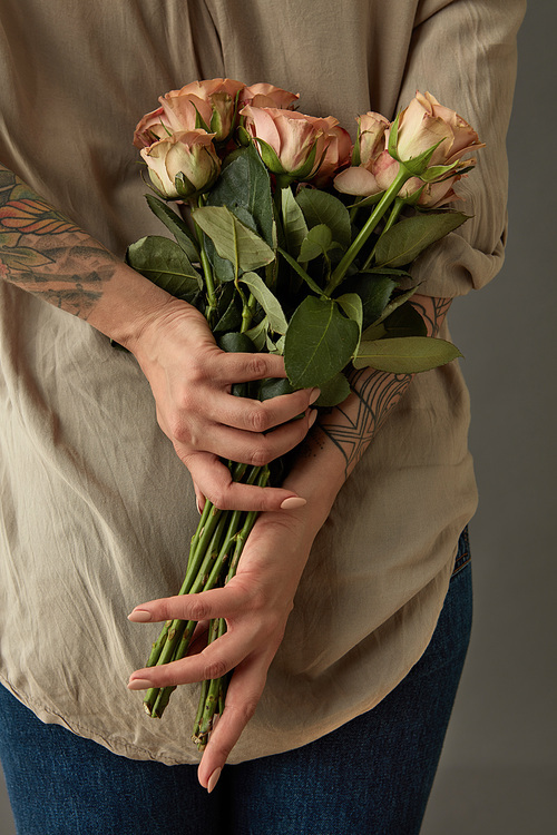 Behind the girl's back is a fresh bouquet of beige roses cappuccino. Mother's Day, Valentine's Day